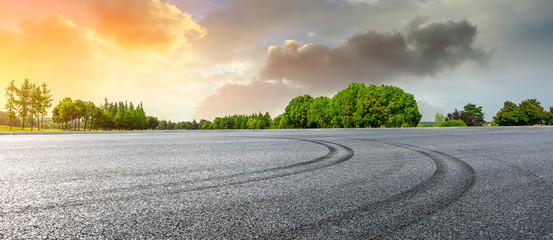 Empty race track and green woods nature landscape at sunset