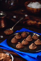 Homemade truffles with dark chocolate on metal tray