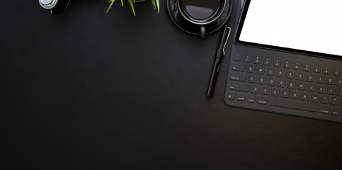 Overhead shot of modern workplace with blank screen tablet and cup of coffee