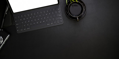 Top view of dark modern workplace with office supplies