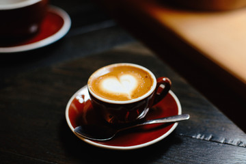 Fresh cup of hot coffee with heart decoration at a coffee shop in New York City, New York
