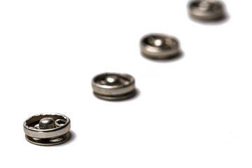 Close up of a group of metal Snap on Buttons on white background.