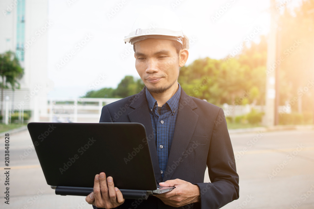 Poster engineer holding computer and working technology