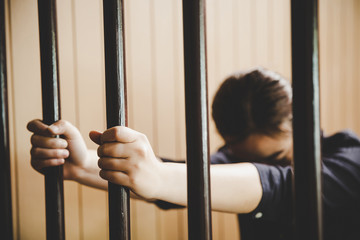 beautiful young girl behind the bars