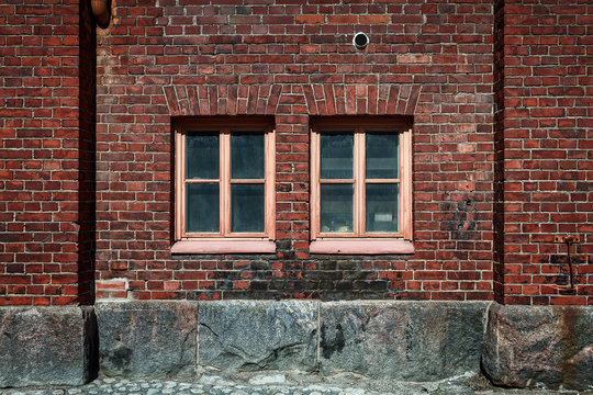 Two Windows On A Brick Wall