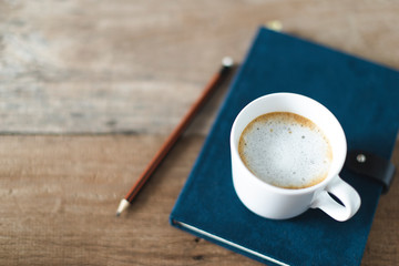 top view a cup of coffee with paper and note book