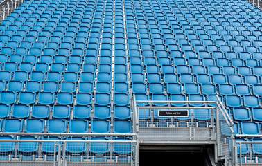 Naklejka premium Blue plastic empty stadium chairs in a row