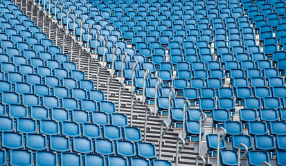 Naklejka premium Blue plastic empty stadium chairs in a row