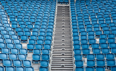 Naklejka premium Blue plastic empty stadium chairs in a row