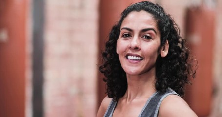 Portrait of strong mixed race female in boxing gym