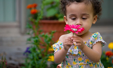 Little girl with a red flower