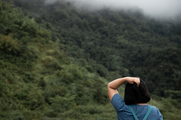 back of woman  with forest background in morning.