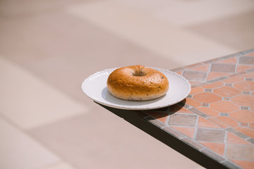 Breakfast Morning Sunny warm weather with donut on white plate on table background. Good mood Horizontal view