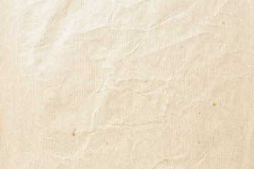 Old pale brown crumpled paper background texture