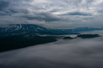 Panoramic view of the city Petropavlovsk-Kamchatsky and volcanoes: Koryaksky Volcano, Avacha Volcano, Kozelsky Volcano. Russian Far East, Kamchatka Peninsula.