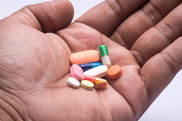 Closeup of a Indian male hand with various medical pills