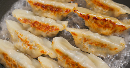 Fry Chinese meat dumpling in pan