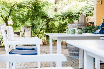 outdoor patio furniture at a cafe, Patio furniture in white. dining on a patio while on vacation