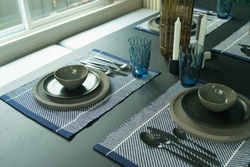 blue tone style of plate setting on dining table 