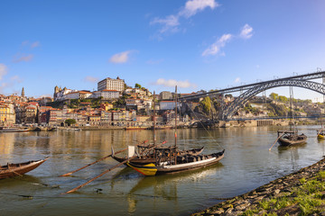 Obraz premium Porto Portugal city skyline at Porto Ribeira and Douro River with Rabelo wine boat and Dom Luis I Bridge