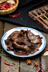 Fresh black agaric slices in a white ceramic dish