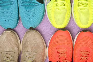 Top view background with four pairs of running shoes