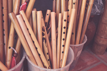 Set of ancient wind musical instruments, lifestyle. Old flutes, bamboo, horns and wooden pipes, vietnam.