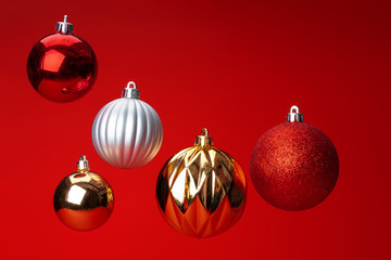 Levitating in air christmas bauble over red  background. Christmas card