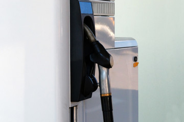 Black fuel pistol on fuel station. Gasoline and petrol products concept. Pumping petrol at gasoline...