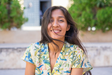 Young indian woman laughing in the street