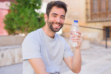 Young man holding a bottle of water