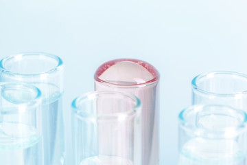 Different laboratory glassware with colored liquids close up