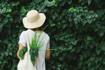 Girl with an eco bag on a juicy green background.
