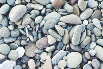 Picturesque sea pebbles close up as background