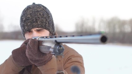 Young hunter pointed his weapon at the bird. Bird hunting concept