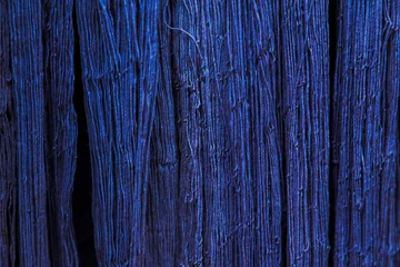 Fotobehang Natural Indigo dye cotton fabric, Cotton yarn dyed blue nature color, traditional fabrics of Thailand, Selective Focus  © monster_code
