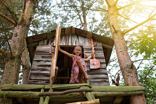 Happy cute kid playing in the treehouse