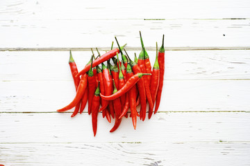 Hot red pepper on a white wooden vintage background.