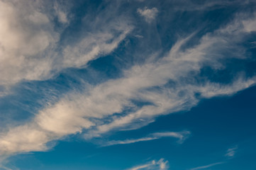 Naklejka na ściany i meble white clouds on a background of blue sky on a sunny day.