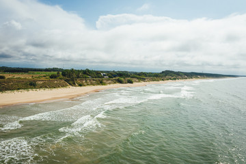 Aerial view of beach, sea waves and sand on baltic coast beach, nature background