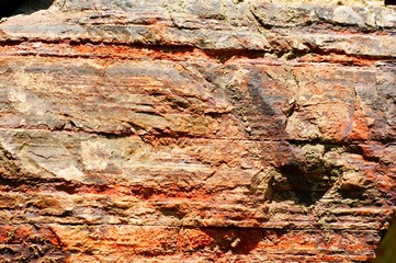 Ancient wall made of large stones of iron ore bonded.