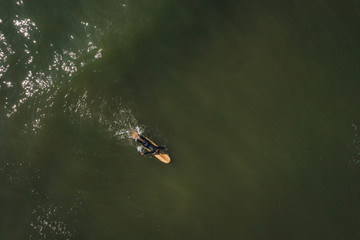 Fototapeta premium Aerial view on surfer in the sea, surfer catching waves in baltic sea.