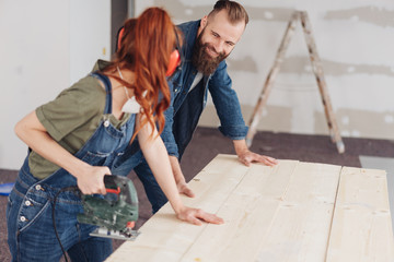 Young couple doing DIY renovations at home