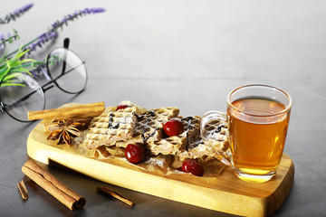 Sweet dessert with waffles and berries for tea at work.