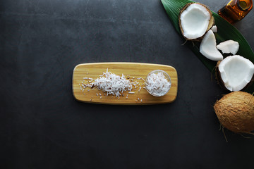 Coconut on a dark stone table. Coconut oil.