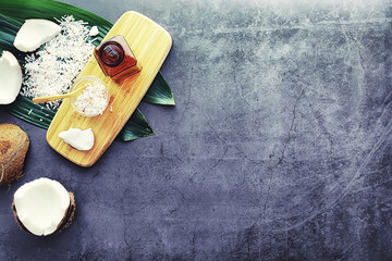 Coconut on a dark stone table. Coconut oil.