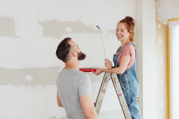 Happy young woman doing renovations at home