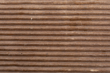Wet brown corrugated or ribbed cardboard texture and background