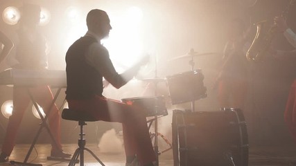 Elegant drummer performing with friends in the cabarets. Free time