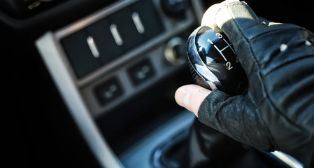 Gear lever. Manual Transmission. Hand on the gear shift in the car.